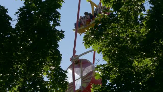 Ungraded: Ferris Wheel at Amusement Park Against Blue Sky