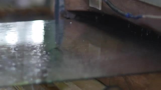 Worker in Yellow Gloves is Putting the Sheet of Glass to Washing Machine, Washing of the Glass