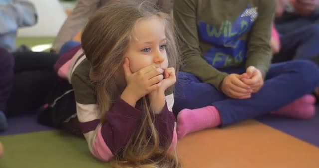 a Girl Are Lies on a Floor in a Kindergarten