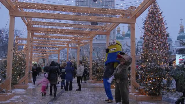 Families Are Walking Animators Minion and Bear People Spend a Time at Sophia Square Bell Tower of a 