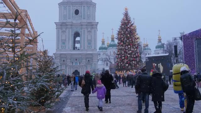 People Are Walking at Decorated Fir Tower Cathedral Tree New Year's Evening on a Sophia Square a