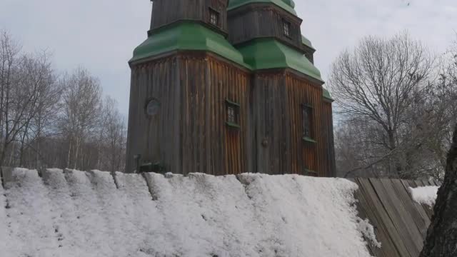 Three Towered Wooden Church Walls Panorama Green Roofs on a Bell Towers Winter Church of Paraskeva t