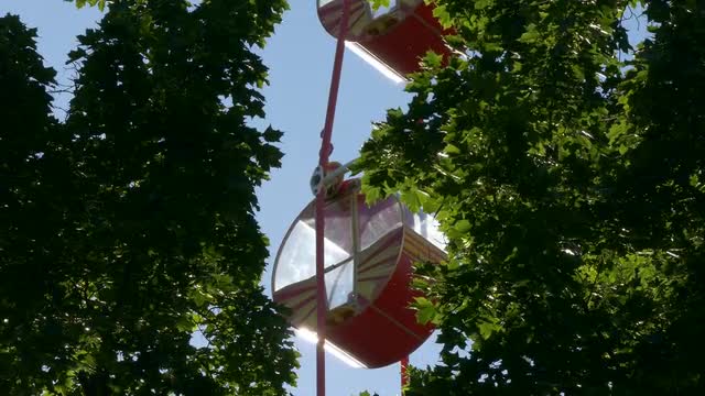 Ungraded: Ferris Wheel at Amusement Park Against Blue Sky