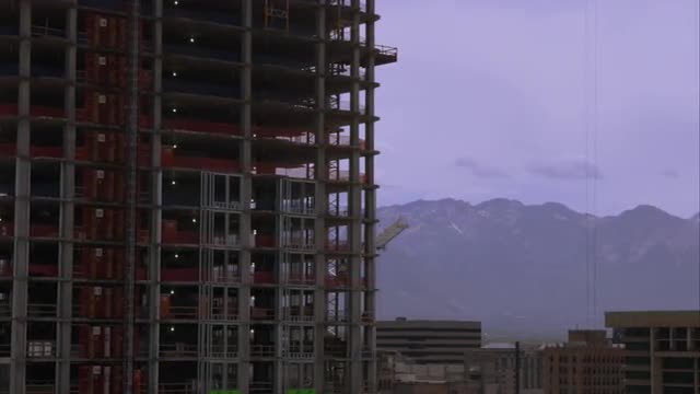 Panning shot of highrise buildingings in Salt Lake City one of which is under construction.