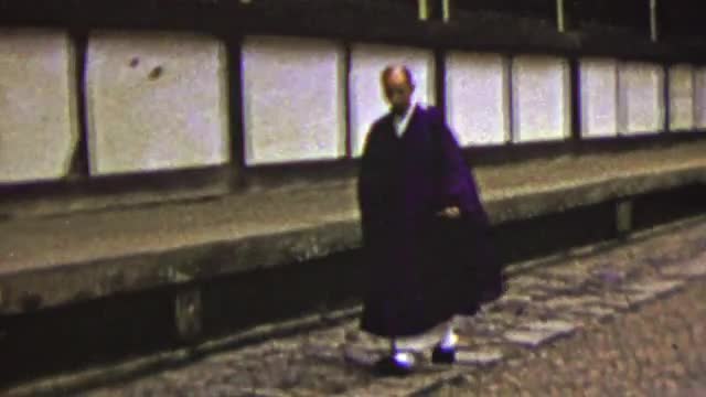 1951: Japanese man traditional robe dress walking alley way street. OSAKA, JAPAN 1951: Japanese man traditional robe dress walking alley way street. OSAKA, JAPAN