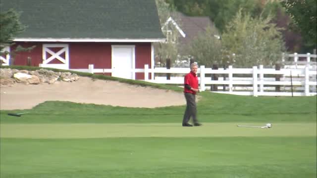 Golfer making a putt and cheering.