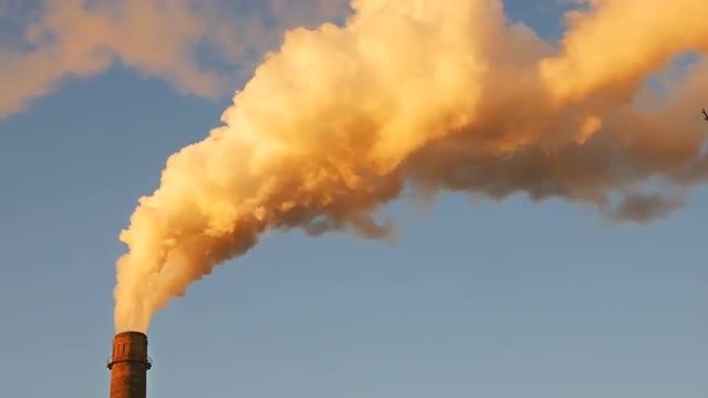 Factory plant smoke stack over blue sky background