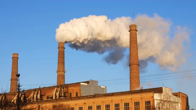 Factory plant smoke stack over blue sky background