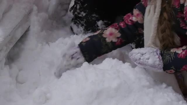 Girl is Piling Snow up in a Heap For Snowman Dad and Daughter Are Playing With Snow Together Snowman