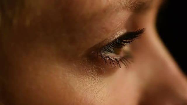 Female eyes closeup side view slow motion