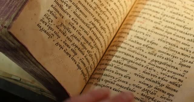 Man's Hand on Old Book Paterik of Kiev-Pecherska Lavra Old-Slavic Writing Engravings Pictures Ep