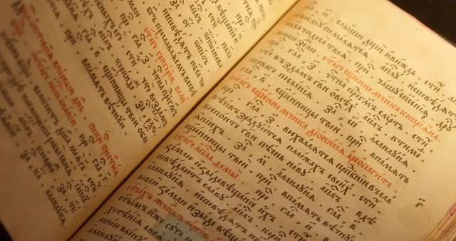 Man's Hands on Old Book Paterik of Kiev-Pecherska Lavra Old-Slavic Writing Engravings Pictures E