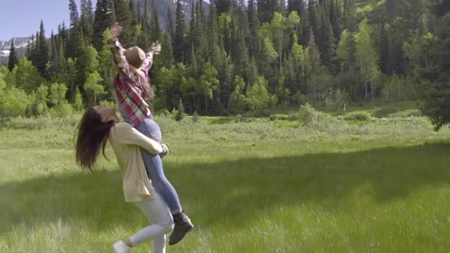 Teenage Girl Runs, Jumps Into Her Best Friend's Arms, They Spin In A Circle (Slow Motion)
