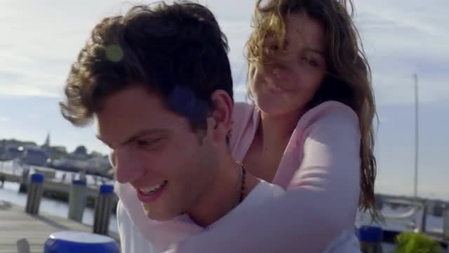 Cute Couple Piggyback On Dock In Marina 