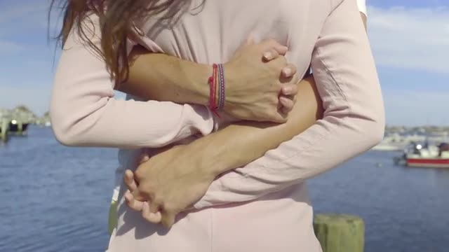 Man Wraps His Arms Around Woman, They Embrace, Very Romantic