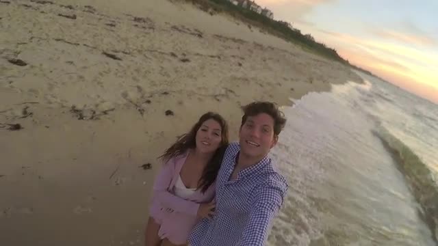 Fun Couple Use Gopro Stick On Beach, They Twirl Around In A Circle And Kiss