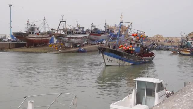 fisherman boats foing to sea, essaouira, morocco