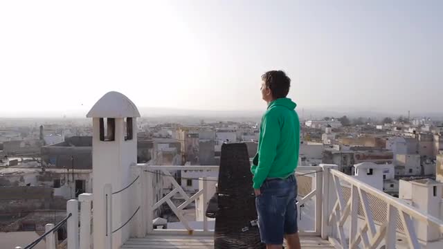 Man stands on top in medina and looking on sky, morocco, essaouira 