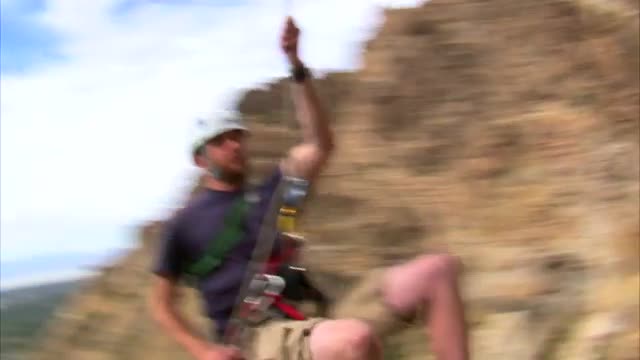 Rock climber hopping over the camera.