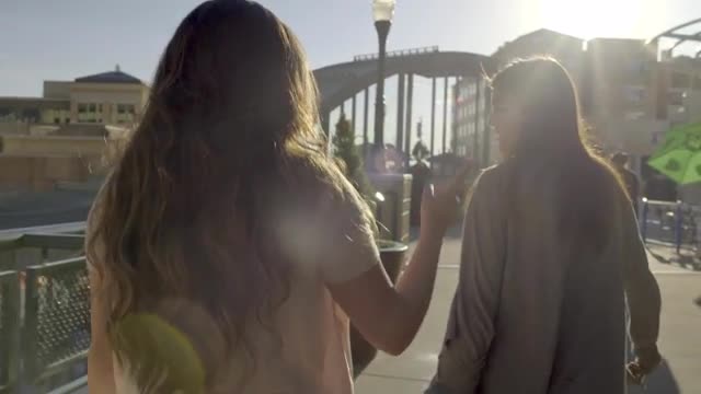 Group Of Girls Walk Around Outdoor Mall, Their Friend Dances Ahead Of Them (Slow Motion)