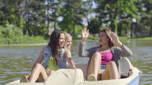 Teen Girls Go For A Ride In A Pedal Boat, One Girl Raises Her Arms And Claps With Excitement (Slow M