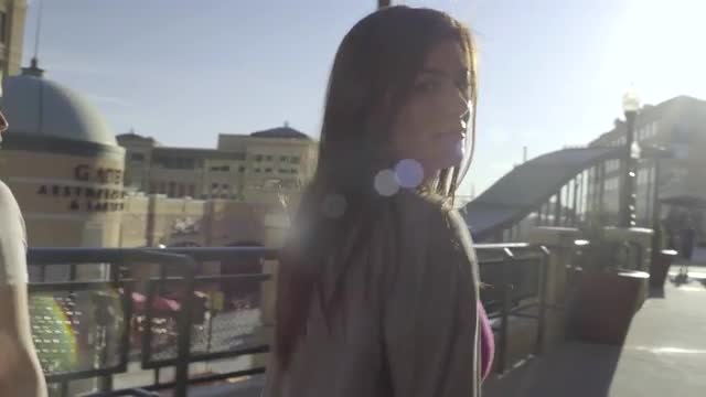 Two Carefree Teenage Girls Walk Around Outdoor Mall, One Girl Dances With Excitement (4K)