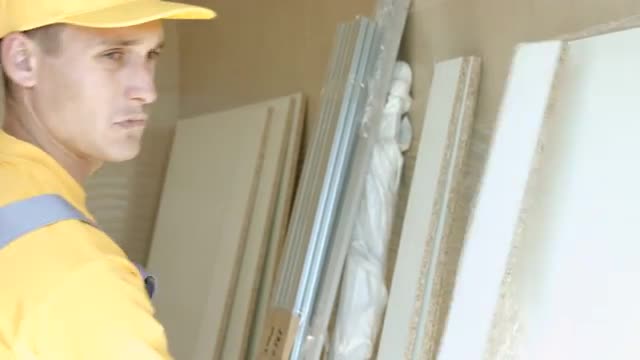 Young Worker Collects Baffles For Further Installation. Assembly Works.