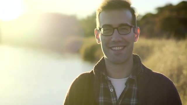 Portrait Of Happy Man Enjoy Sunset In Nature