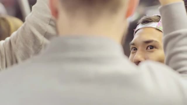 Closeup Of Gay Couple Listening To Friend's Story On Subway Train Ride