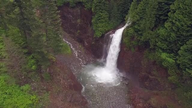 Rising Aerial of Forest Canyon with Waterfall
