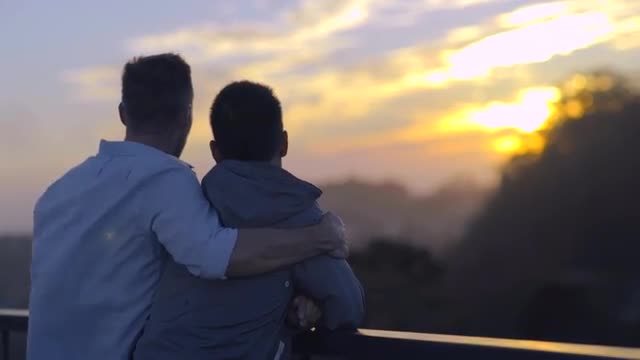 Gay Couple Watch Sunset From Scenic Overlook In San Francisco 