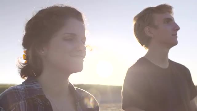 Young Couple Enjoy Sunset On The Beach In Summer