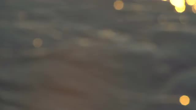 Abstract Gold Bokeh Reflections on the Water Surface