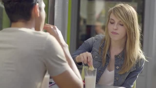 Cute Couple Enjoy A Date Together, They Eat Cookies And Milk, Young Woman Dunks Her Cookie In Milk (