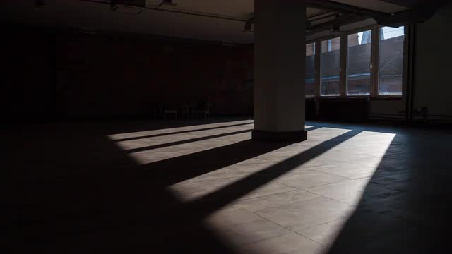 Timelapse of sun rays moving over an empty office space