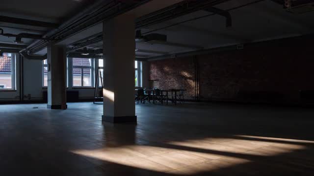 Timelapse of sun rays moving over an empty office space