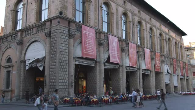 Restaurant table out front of buildings in Bologna, Italy.