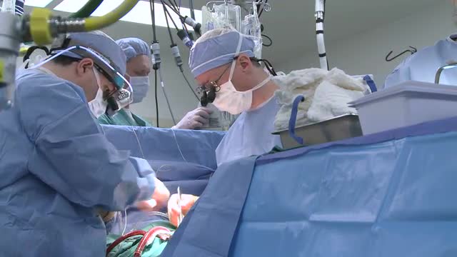 Doctors performing open heart surgery