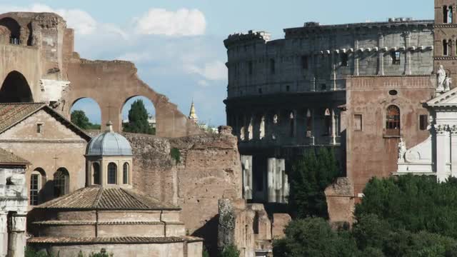 Ancient ruins with the Coliseum in the background in Rome.