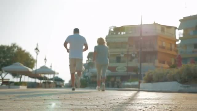 Active senior people jogging on resort