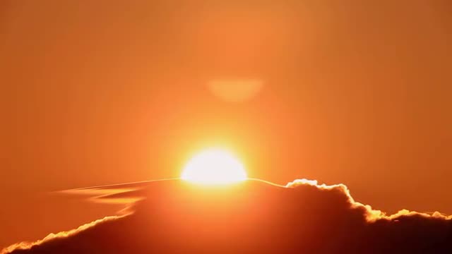 Sun rising up against the clouds