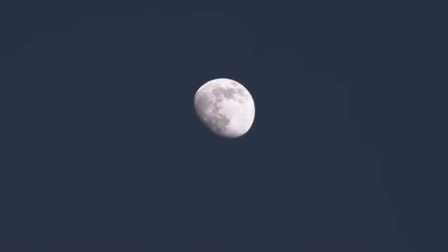 Three quarter moon in clear night sky.
