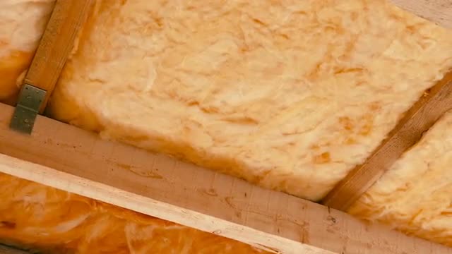 Man Insulating Roof With Fiberglass (Glasswool)