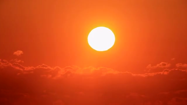 Sun rising up against the clouds