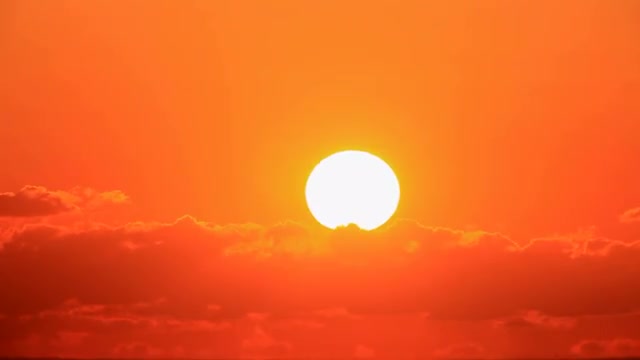 Sun rising up against the clouds