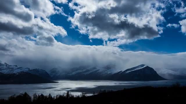 Dynamic clouds and fjord landscape