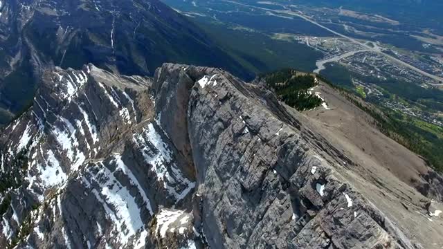Aerial birds eye view of ridge line at the peak of a mountain 