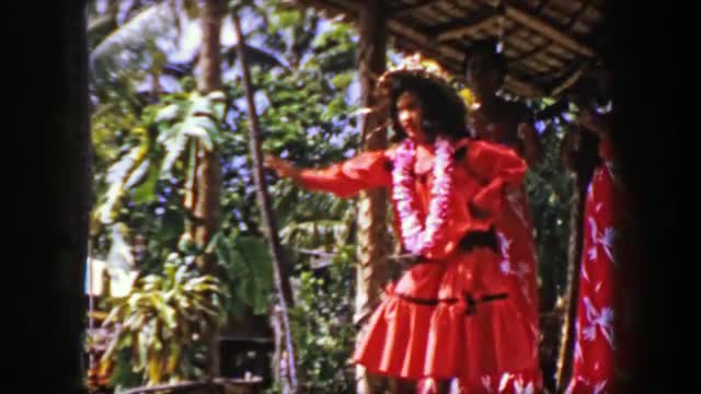 1958: Teenage hula dancer storytelling performance on outdoor stage. HONOLULU, HAWAII