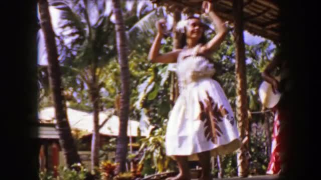 1958: Native Hawaiian hula dancer storytelling performance on outdoor stage. HONOLULU, HAWAII