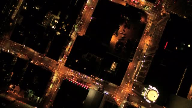 Aerial vertical view at night of city traffic, streets and skyscrapers, USA